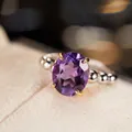 Macro detail of oval purple gemstone set in gold claw on beaded silver ring band - Beaded Band Elegant Style (LR259)