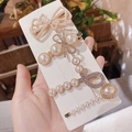4-piece set of white pearl and rhinestone hair clips with gold-tone alloy base - Bowknot Pearl 4-Piece Set