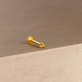 Macro shot of gold trinity bead labret stud featuring three polished beads on flat back post - Gold Trinity Three Beads