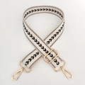 Detail of beige nylon strap with black arrow pattern and gold metal buckles - Beige Webbing with Silver Buckle