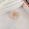 Elegant shell-shaped hair claw clip in pearl white finish with gold striped pattern - Mermaid White