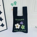 Black knit tote bag featuring colorful flower embroidery and white letter stitching - Three Flowers Black