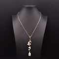 Elegant gold sweater chain featuring freshwater pearls and long drop pendant on a black bust - Baroque Pearl Pendant Sweater Chain