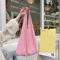 Pink cotton canvas tote bag featuring a knotted strap detail and soft fabric texture - Pink