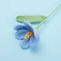 Close-up detail of handcrafted blue yarn tulip with intricate knitted texture and leaf - Finished Open Tulip Bouquet (blue)