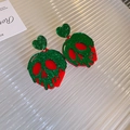 Detail of Halloween acrylic skull heart earrings with toxic apple glitter design - Green Heart Skull Drop Earrings