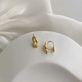 Elegant gold twisted knot earrings set on white silk background for a minimalist style - Gold Twisted Knot Earrings