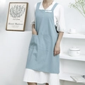 Light blue cotton linen apron with H-back design and large front pocket on model - Light Blue