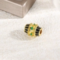 Detailed macro shot of oval dopamine bead with green zircons and black enamel stripes - Black
