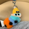 Detail of plush caterpillar keychain with yellow hat and glasses on a beige background - Flesh Pink Orange Tail