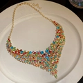 Detail of vintage gold V-shaped necklace with colorful crystals on ceramic plate - 66# Necklace-Gold-Multicolor