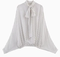 Close-up of white polka dot blouse with elegant bow tie neck and loose batwing sleeves - XS / Tops / White
