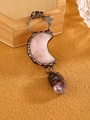 Detail of rose quartz moon and purple crystal pendant set in bronze star frame - Rose Quartz
