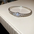 Macro shot of silver-tone link bracelet with shimmering pavé cubic zirconia center element - Pave Round Decor Cuban Link / Silver