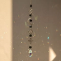 Close-up of crystal prism throwing rainbow light with silver moon and star ornaments - Style 2 (47cm, 32g)