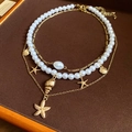 Layered gold starfish and pearl necklace set with shell pendants for beach vacation - Gold Conch Starfish Pearl Shell Layered Necklace 3-Piece Set
