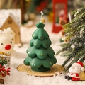 Green Christmas tree scented candle with colorful ornaments on a wooden base - Christmas Green