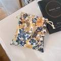Close-up of vintage oil painting style floral drawstring pouch with cotton ropes - Blue Yellow Floral On White