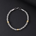 Detailed view of silver and gold twisted rope bracelet with lobster clasp on black background - 5mm Twist Rope Chain With Gold Beads Bracelet / 21cm