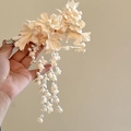Detail of cream Lily of the Valley hair clip with pearl tassels and petal textures - White
