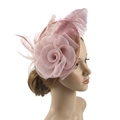 Pink fascinator hat with mesh veil and feathers shown on a model for wedding party - Lotus root pink