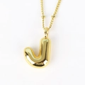 Close-up of balloon-style golden letter J pendant necklace with high mirror polish - Letter J