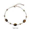Detailed macro view of the gold chain tiger's eye bracelet with an adjustable tail chain - Gold-Tiger's Eye