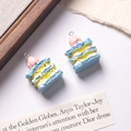 Macro shot of miniature mille-feuille resin charms for DIY jewelry and keychain making - Blue + Yellow Filling