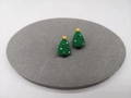 Detail of Christmas tree stud earrings with festive ornaments on a grey velvet display - Christmas Tree