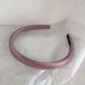 Detail of pink satin headband featuring a black 'Hand Made' label on white paper - Pink