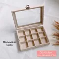 Detalle de joyero beige con 12 compartimentos, hebillas plateadas y tapa de vidrio de 20x15x5cm - 12 Rejillas Hebilla Única / Beige