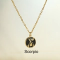 Luxury gold titanium Scorpio necklace featuring a black round pendant with fine diamonds - Scorpio