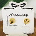 Gold star-shaped earrings with colorful zircon stones on white display card - Round Style