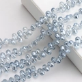 Close-up of iridescent blue teardrop glass crystal beads for DIY jewelry making - 100 Pcs/Pack / Light Blue Grey
