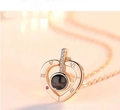 Detail of rose gold heart pendant with projection stone and Roman numeral engraving - Heart Rose Gold