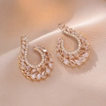 Elegant gold earrings with sparkling zircon leaf design on champagne silk fabric - Golden Wings Pave Style (E0863)