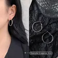 Detail view of 3cm silver minimalist hoop earrings on model and in a still life studio set - 3cm / Minimalist Hoop / Silver