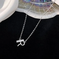 Elegant silver letter R pendant necklace with sparkling cubic zirconia on black velvet background - 925 Silver / Silver (Initial R)