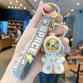 Cartoon astronaut keychain in white and gold finish with grey silicone space strap - Dazzling Astronaut-Yellow