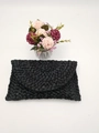 Handmade black woven corn husk clutch bag with a semi-circular flap and textured pattern - Black