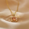 Macro view of gold square pendant necklace with champagne gemstone and small diamonds - Gold Pink