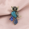 Vintage golden owl brooch with blue rhinestones and dark gems on a branch - Vintage Gold Blue Gem Owl (XD9194)