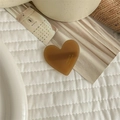Detailed close-up of brown heart-shaped acetate hair clip with gold France Handmade logo - Coffee