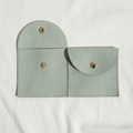 Light green microfiber jewelry pouch with curved snap closure on white fabric background - 8*8cm / Light Green