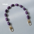 Close-up of a 34cm purple acrylic bead bag strap with lobster clasps on gray fabric - Purple-34CM