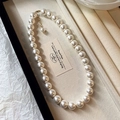Detailed macro view of a French retro pearl necklace with lustrous white beads - Necklace Style 41 / 12mm Pearl / Gold-White