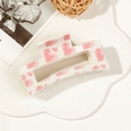 Detail of pink heart patterns on a white rectangular claw clip with a glossy finish - 8.5cm Heart Print - Style B White Base