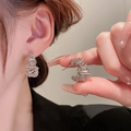 Detail shot of silver metallic fringe earrings featuring spiral winding design on model - Irregular Spiral Wrapped Earring (26#)