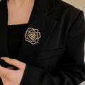Close-up of a sparkling crystal camellia brooch pinned on a black luxury blazer lapel - Pave Camellia