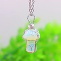 Macro shot of silver wire wrapped mushroom pendant with opal stone on a simple chain - Opalite Silver-tone